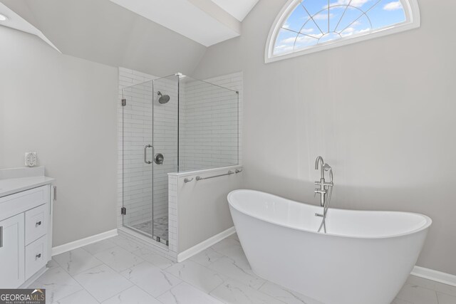 bathroom with vanity, marble finish floor, baseboards, a freestanding tub, and a shower stall