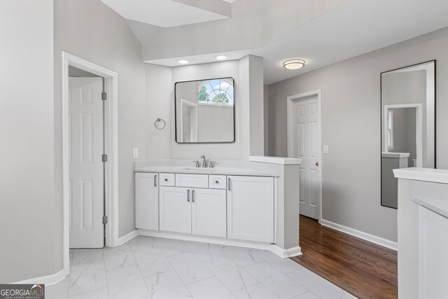 bathroom with baseboards, recessed lighting, marble finish floor, and vanity