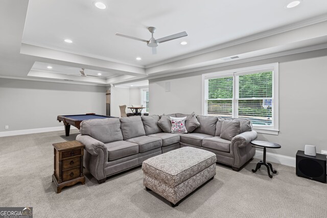 living room featuring crown molding, a raised ceiling, baseboards, and carpet