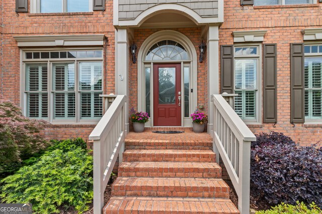 entrance to property with brick siding