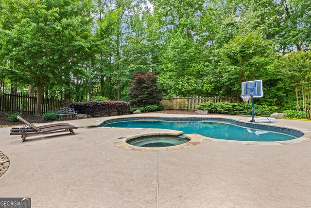 view of swimming pool with a fenced in pool, a fenced backyard, a patio area, and an in ground hot tub