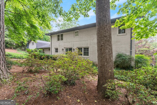 back of house featuring brick siding