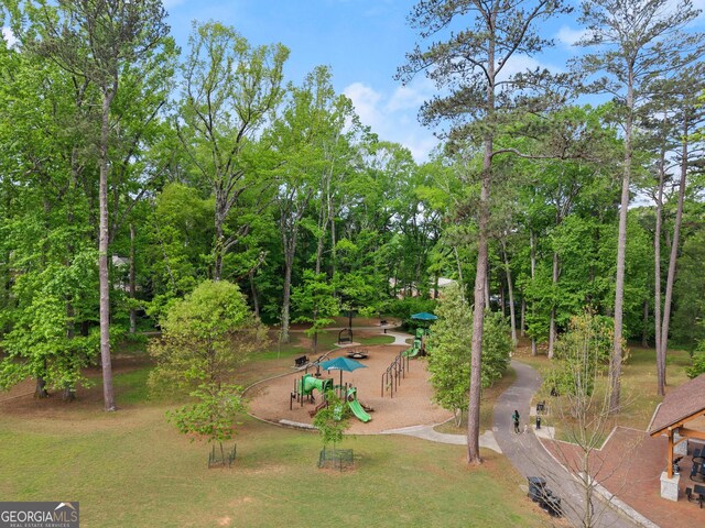 surrounding community featuring a lawn and playground community