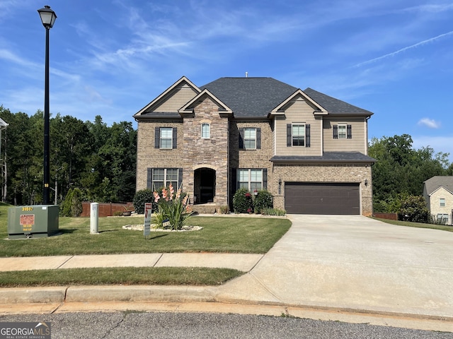 292 Aylesbury Blvd, Mcdonough, GA 30252 - view of front facade with concrete driveway, an attached garage, a front yard, and stone siding