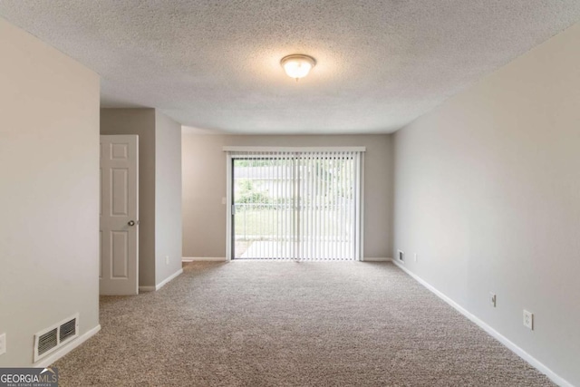 6255 Saddlewood Dr, Lithonia, GA 30058 - spare room with carpet flooring and a textured ceiling