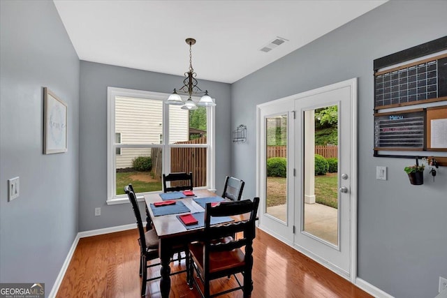 dining space with wood finished floors and baseboards