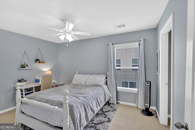 bedroom featuring light carpet, baseboards, and a ceiling fan