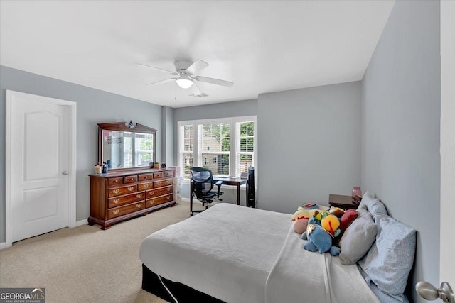 bedroom featuring light carpet, ceiling fan, and baseboards