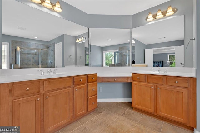 bathroom featuring a shower stall, vanity, tile patterned floors, and baseboards