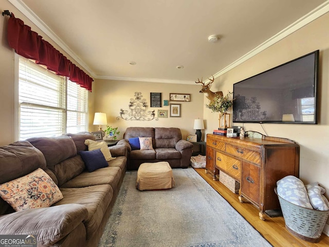 living room with crown molding and wood finished floors