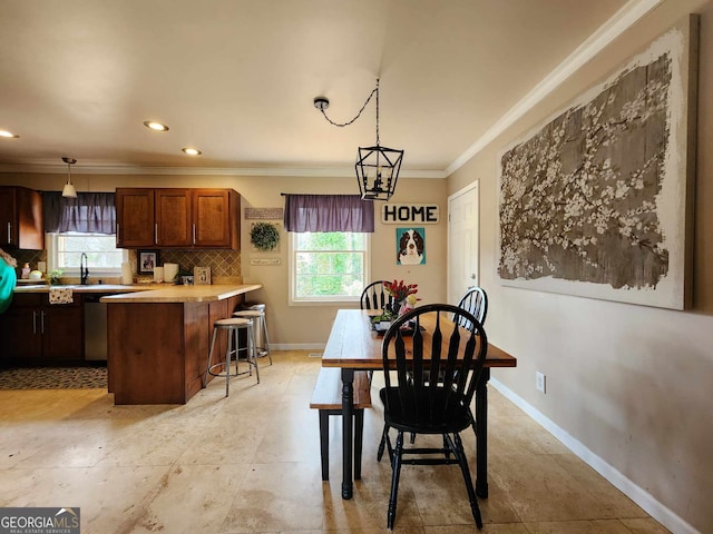 dining space with plenty of natural light, ornamental molding, baseboards, and recessed lighting