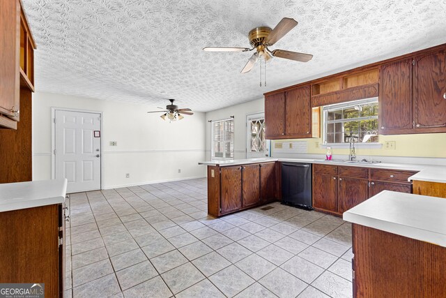kitchen with a sink, stainless steel dishwasher, a ceiling fan, and light tile patterned flooring