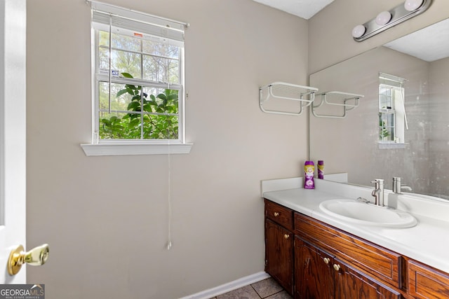 bathroom featuring baseboards, tile patterned flooring, and vanity