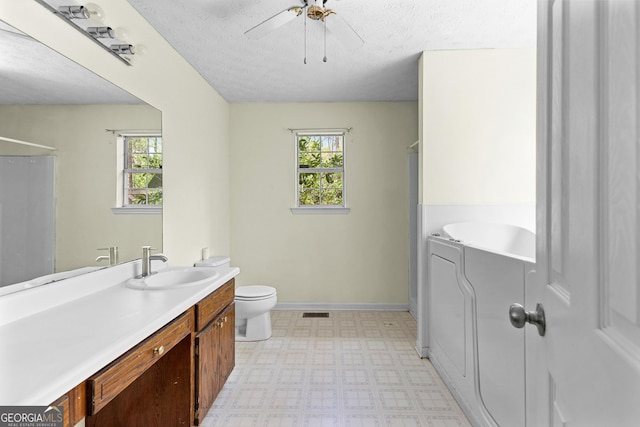 full bath with vanity, toilet, tile patterned floors, a ceiling fan, and baseboards
