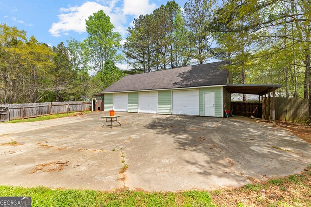 garage featuring a garage and fence
