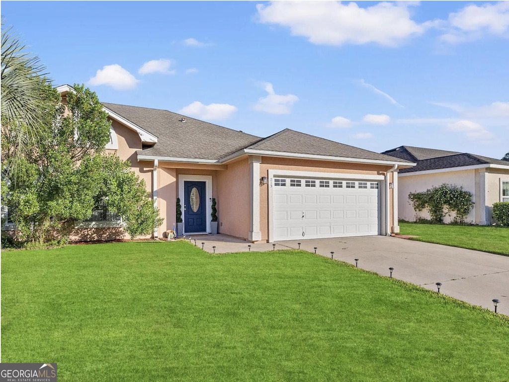 single story home with an attached garage, concrete driveway, stucco siding, and a front yard