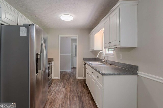 5028 Nichols Dr, Flowery Branch, GA 30542 - kitchen with stainless steel refrigerator with ice dispenser, white cabinets, a textured ceiling, dark wood-style floors, and dark countertops