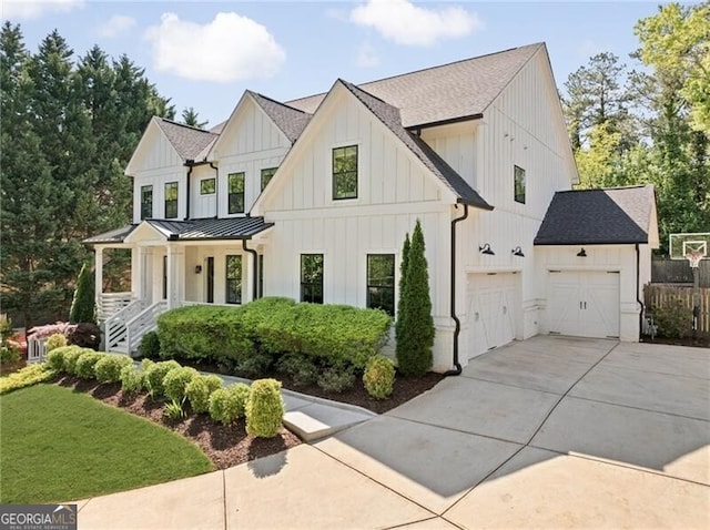 view of front of home featuring driveway, board and batten siding, a standing seam roof, metal roof, and a shingled roof
