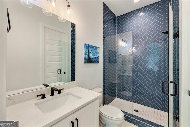 full bathroom with vanity, toilet, and a shower stall