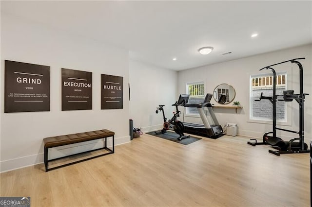 exercise area featuring recessed lighting, baseboards, and wood finished floors