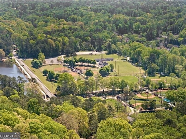 birds eye view of property featuring a water view and a forest view