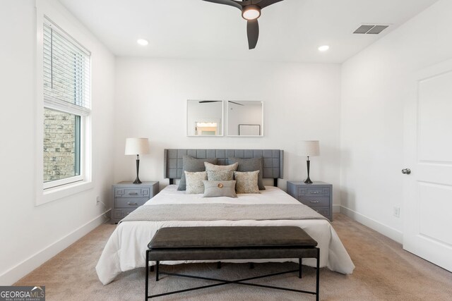 bedroom featuring visible vents, baseboards, and light carpet