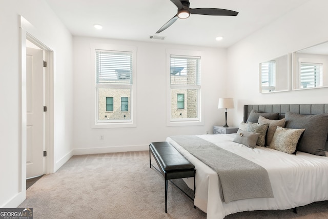 carpeted bedroom featuring visible vents, a ceiling fan, and baseboards