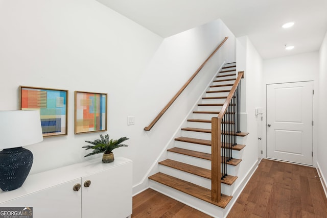 stairway featuring recessed lighting, baseboards, and wood finished floors