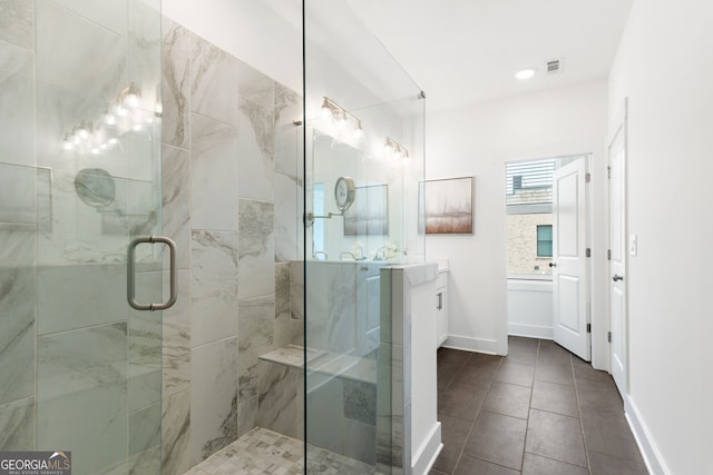 full bath with vanity, tile patterned floors, baseboards, a shower stall, and visible vents