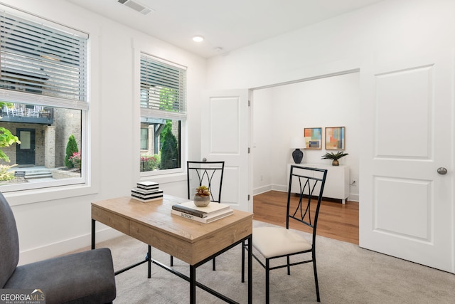 office with baseboards, light wood-type flooring, and visible vents