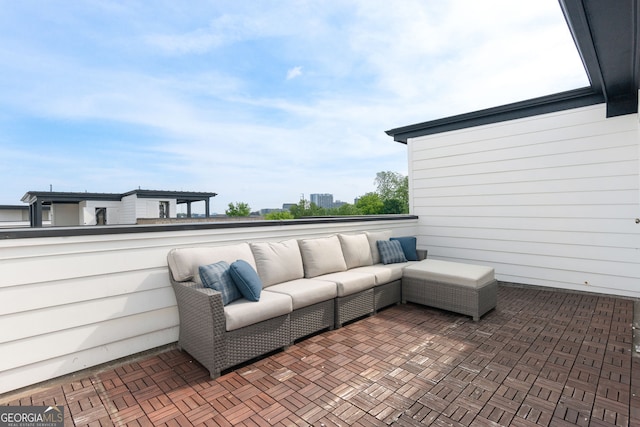 view of patio with an outdoor living space and a balcony