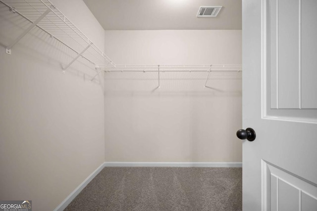 spacious closet featuring visible vents and carpet