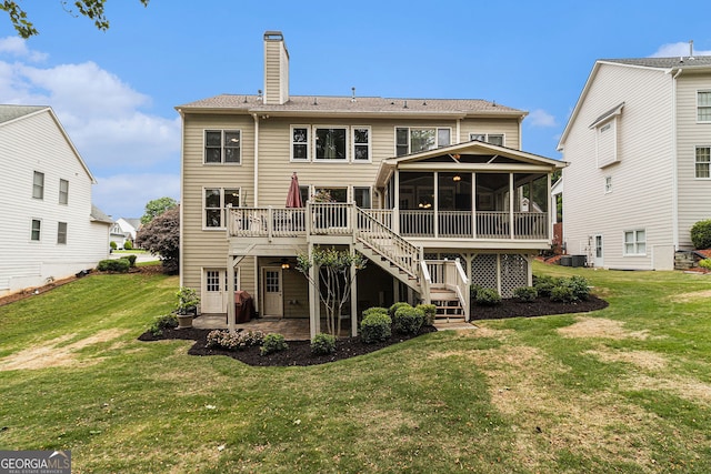 139 Ardsley Run, Canton, GA 30115 - back of property with a sunroom, a patio, a chimney, stairway, and a deck