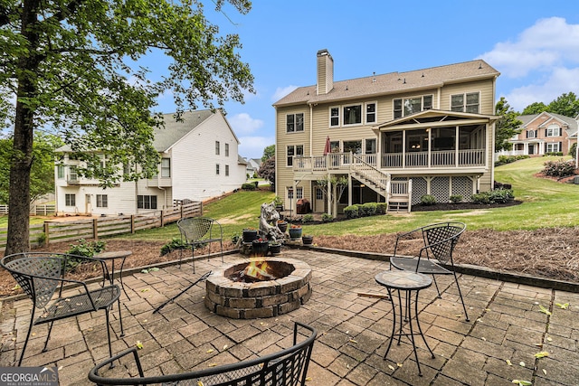 139 Ardsley Run, Canton, GA 30115 - back of property with an outdoor fire pit, a sunroom, a patio area, and a chimney