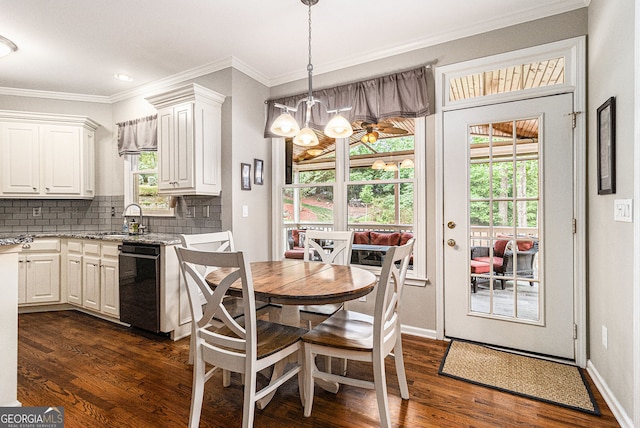 139 Ardsley Run, Canton, GA 30115 - dining space featuring dark wood-style floors, ornamental molding, and a chandelier