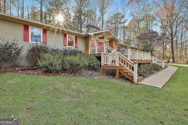 337 Andrew Bailey Rd, Sharpsburg, GA 30277 - view of front of house with stairway, a chimney, a wooden deck, and a front yard