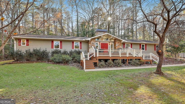 337 Andrew Bailey Rd, Sharpsburg, GA 30277 - single story home featuring a deck, stone siding, a front yard, and a chimney