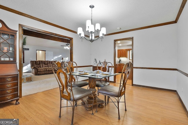 337 Andrew Bailey Rd, Sharpsburg, GA 30277 - dining area with a ceiling fan, light wood-type flooring, a chandelier, crown molding, and a textured ceiling
