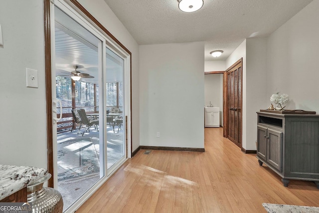 337 Andrew Bailey Rd, Sharpsburg, GA 30277 - corridor featuring light wood-style flooring and a textured ceiling