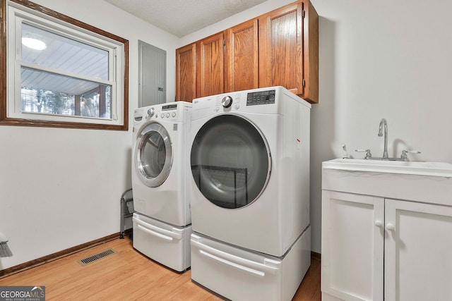 337 Andrew Bailey Rd, Sharpsburg, GA 30277 - laundry room with cabinet space, separate washer and dryer, and light wood-type flooring