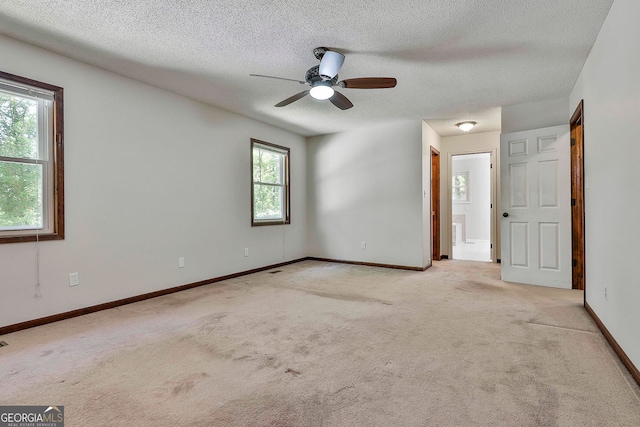 337 Andrew Bailey Rd, Sharpsburg, GA 30277 - unfurnished bedroom with carpet, a textured ceiling, ensuite bath, and ceiling fan