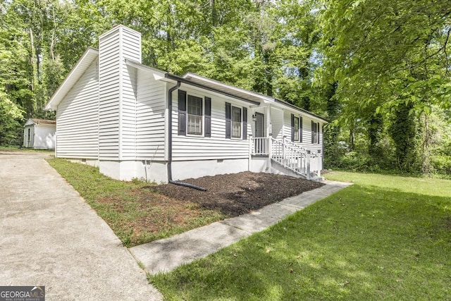 522 Wilderness Dr, Macon, GA 31220 - ranch-style house with a chimney, crawl space, a front yard, driveway, and view of wooded area