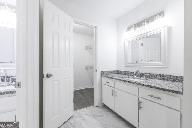 522 Wilderness Dr, Macon, GA 31220 - bathroom featuring marble finish flooring, vanity, and a spacious closet