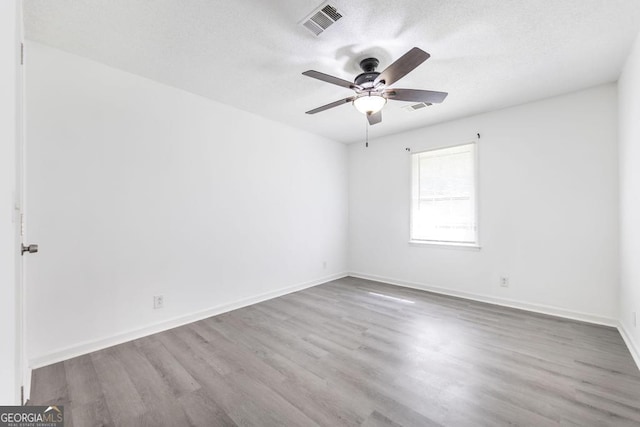 522 Wilderness Dr, Macon, GA 31220 - unfurnished room with a ceiling fan, wood finished floors, a textured ceiling, and baseboards