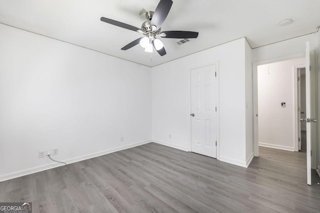 522 Wilderness Dr, Macon, GA 31220 - unfurnished bedroom with wood finished floors, baseboards, and a ceiling fan