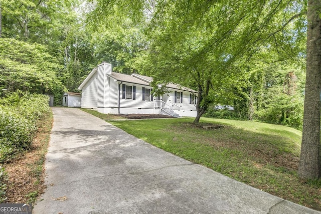 522 Wilderness Dr, Macon, GA 31220 - view of front of home with crawl space, a front yard, a chimney, and an outbuilding