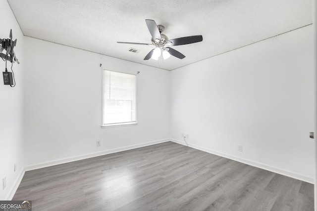 522 Wilderness Dr, Macon, GA 31220 - unfurnished room with wood finished floors, ceiling fan, a textured ceiling, and baseboards