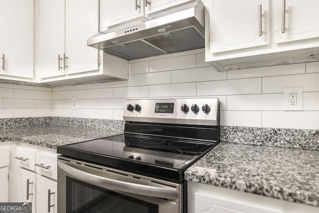 522 Wilderness Dr, Macon, GA 31220 - kitchen with stainless steel electric range oven, under cabinet range hood, white cabinets, and decorative backsplash