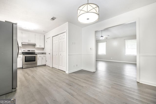 522 Wilderness Dr, Macon, GA 31220 - kitchen featuring appliances with stainless steel finishes, white cabinetry, light wood-type flooring, ceiling fan, and decorative backsplash