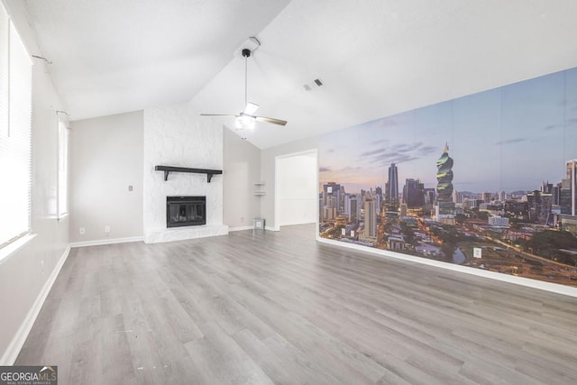 522 Wilderness Dr, Macon, GA 31220 - unfurnished living room featuring a ceiling fan, wood finished floors, a large fireplace, lofted ceiling, and a skyline view
